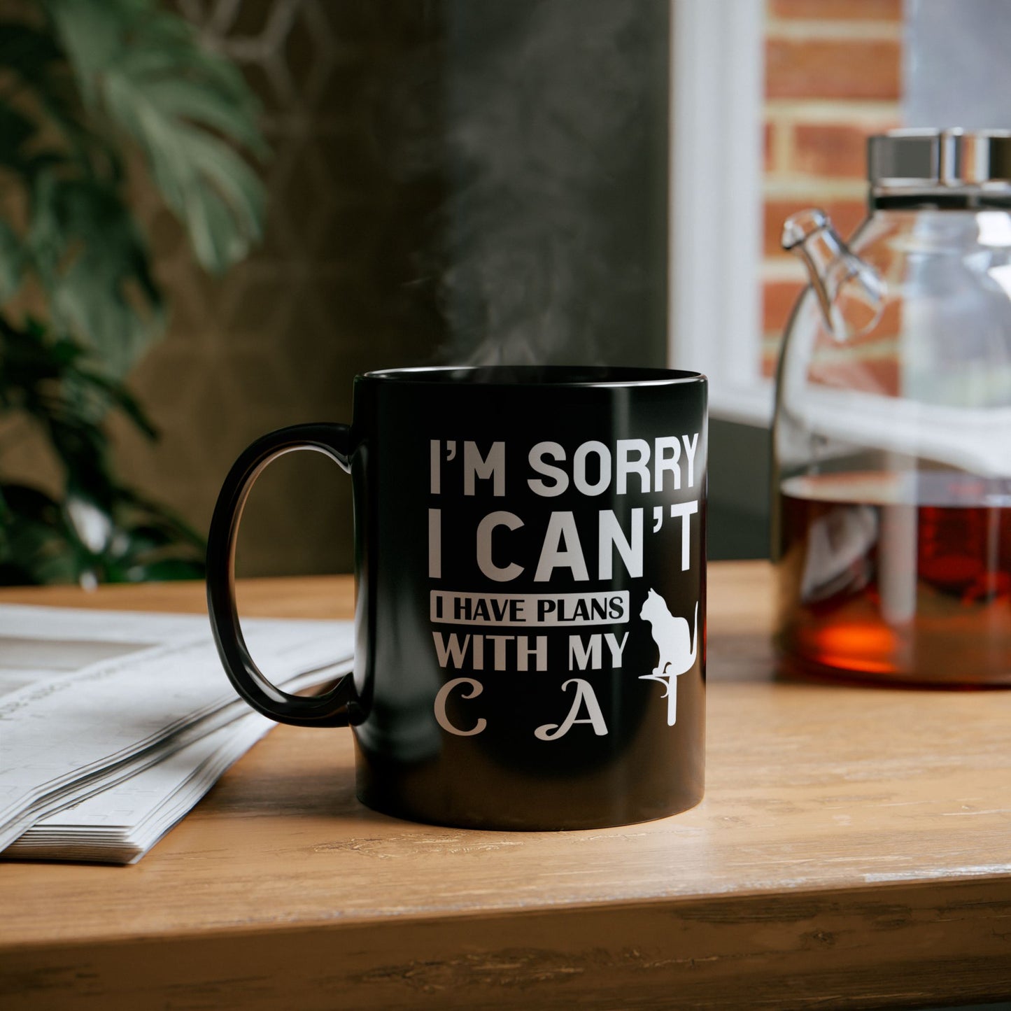 Black mug with white text "I'm Sorry I Can't I Have Plans With My Cat" and a cat graphic.