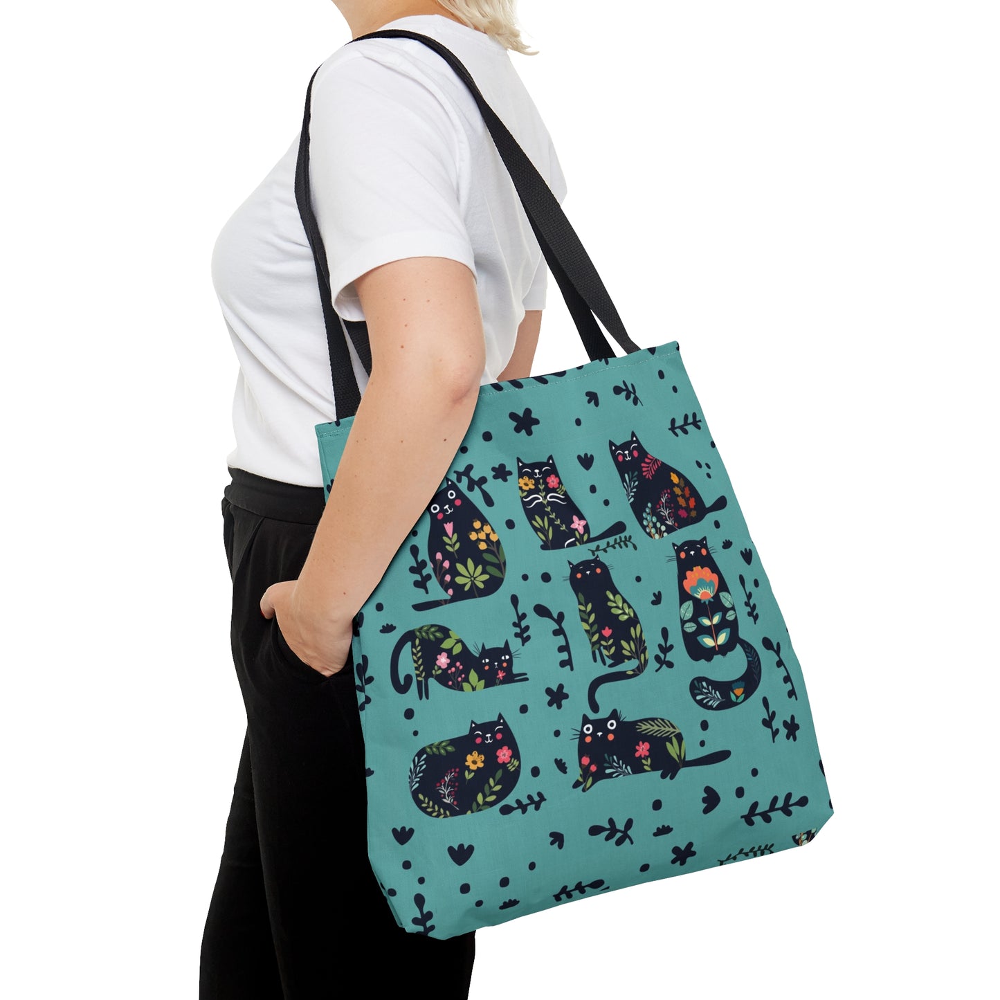 Blue Tote bag with black illustrated cats and flowers pattern.