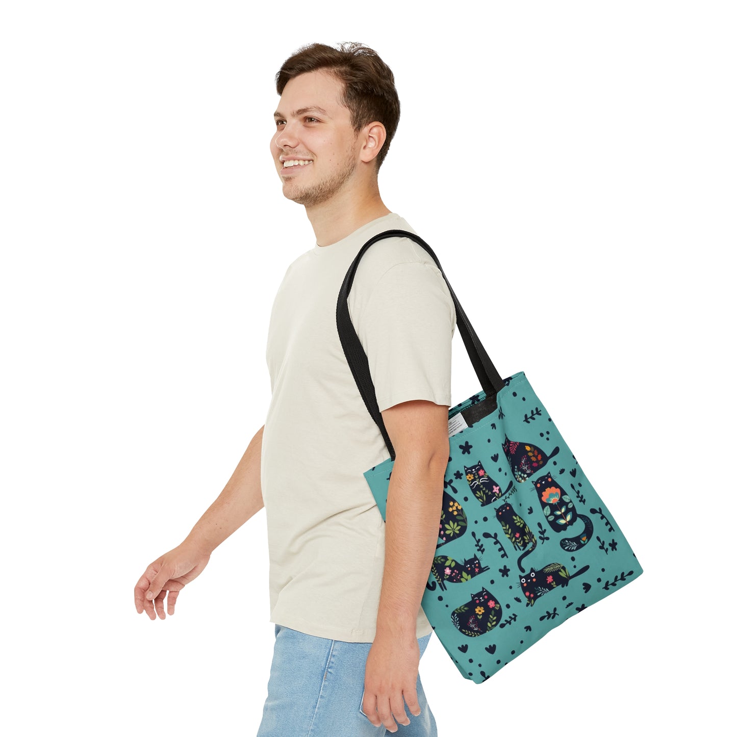 Blue Tote bag with black illustrated cats and flowers pattern.
