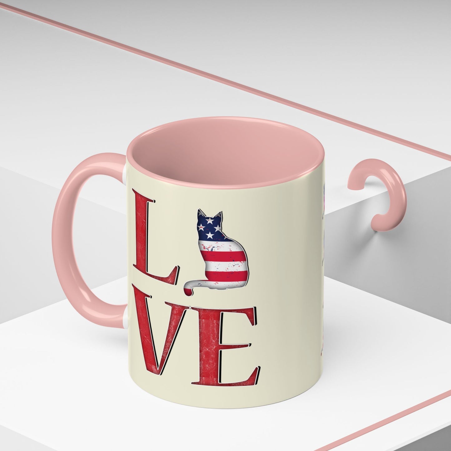 Pink mug with LOVE text and cat silhouette graphics in colors of American flag.