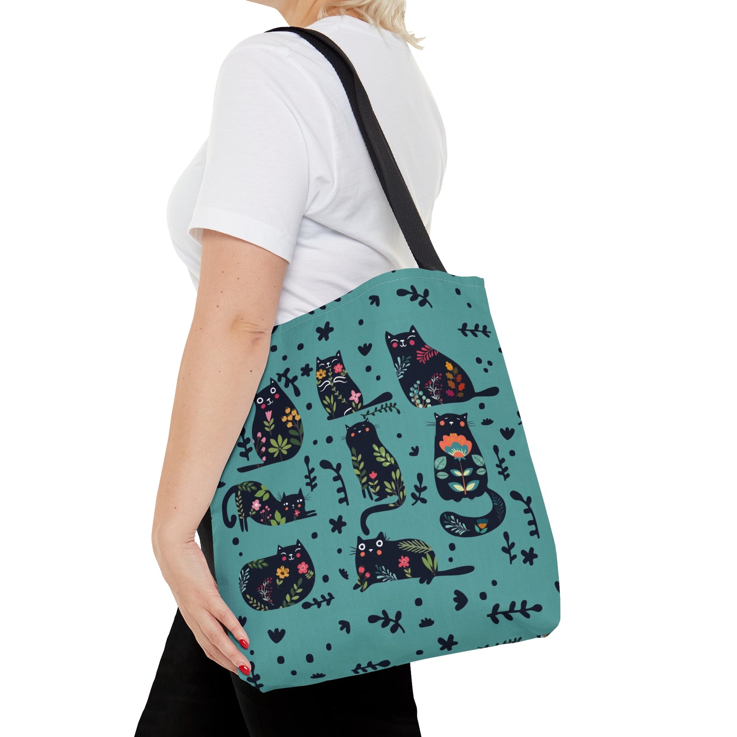Blue Tote bag with black illustrated cats and flowers pattern.