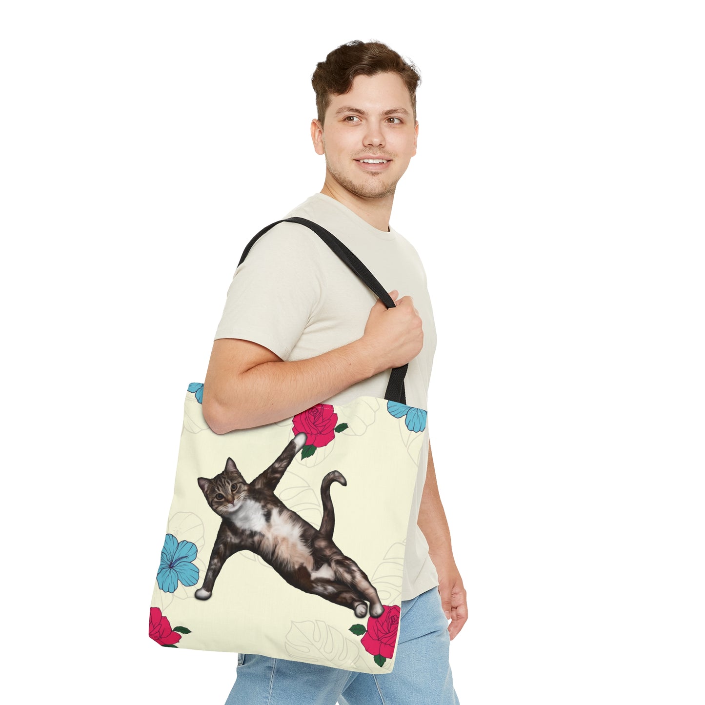 Tote bag with a cat in a yoga pose illustration against floral design on a cream background