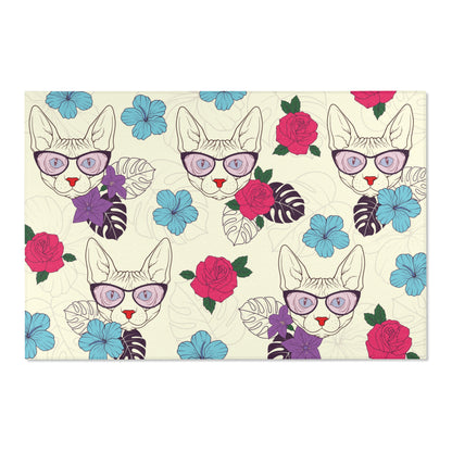 Area rug with a pattern of cartoon Sphynx cats and tropical flowers on a cream background