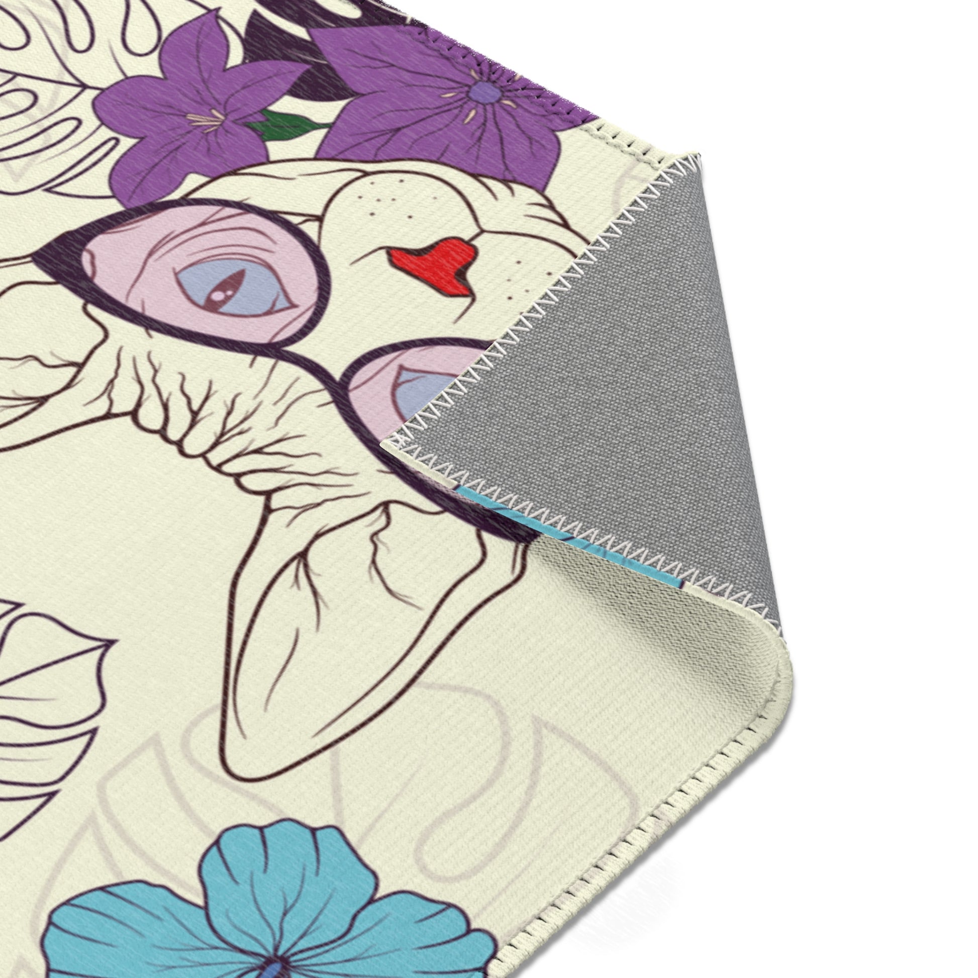 Area rug with a pattern of cartoon Sphynx cats and tropical flowers on a cream background