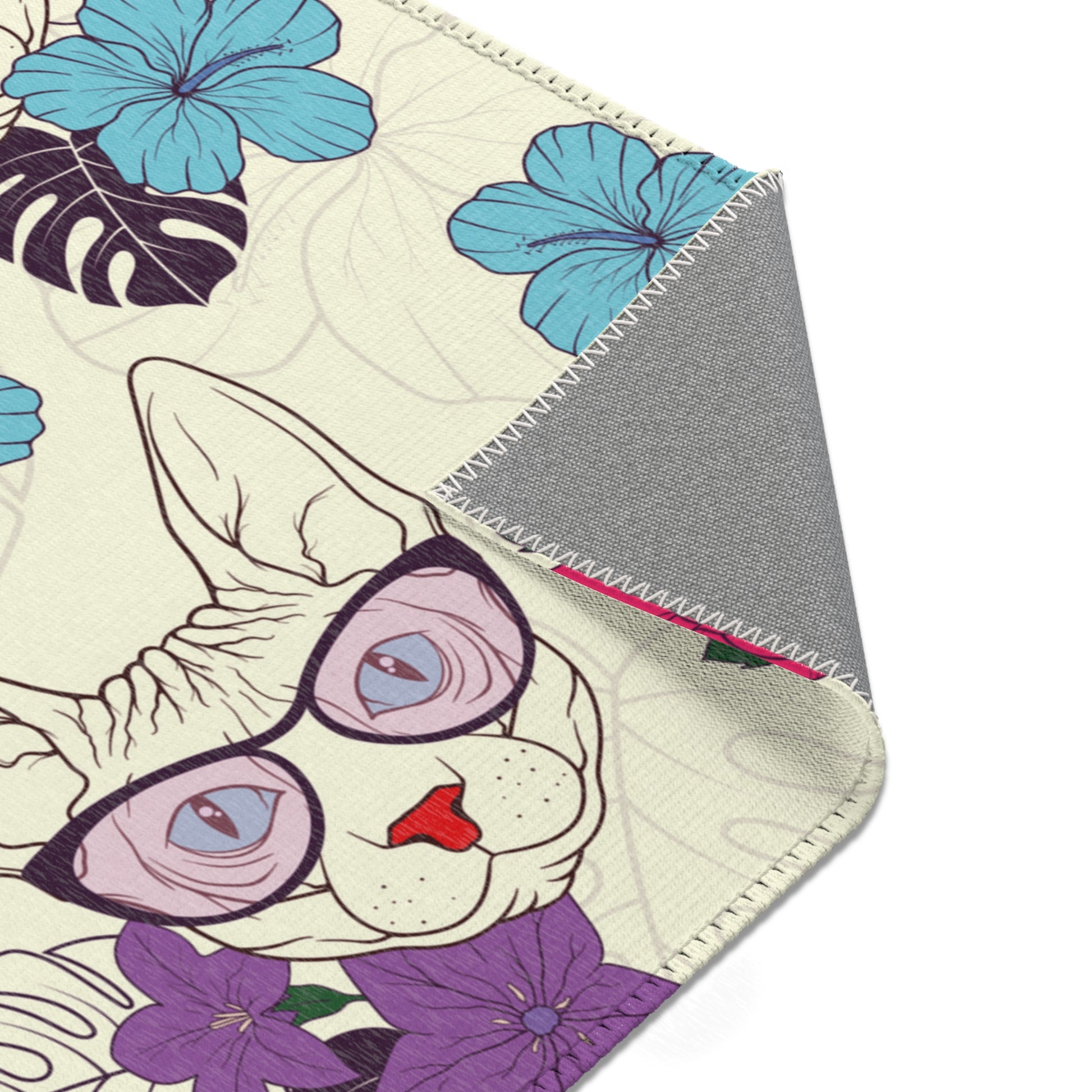 Area rug with a pattern of cartoon Sphynx cats and tropical flowers on a cream background