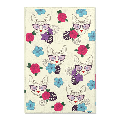 Area rug with a pattern of cartoon Sphynx cats and tropical flowers on a cream background