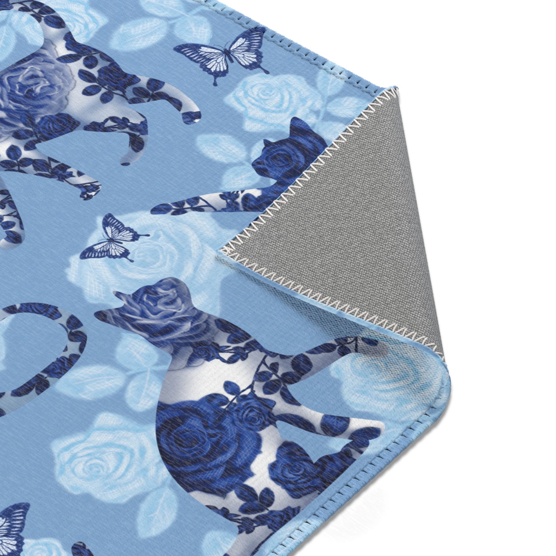 Area rug with cats, butterflies & roses motif on a blue background