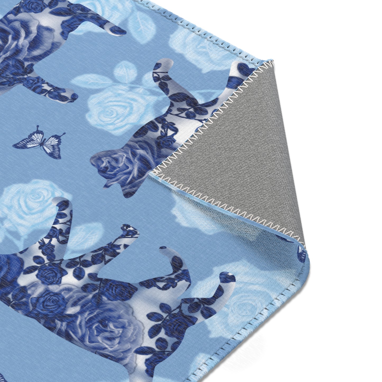 Area rug with cats, butterflies & roses motif on a blue background