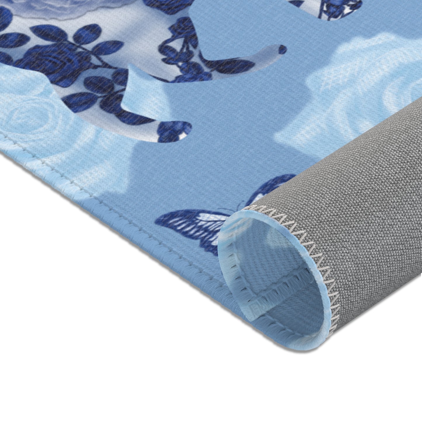 Area rug with cats, butterflies & roses motif on a blue background