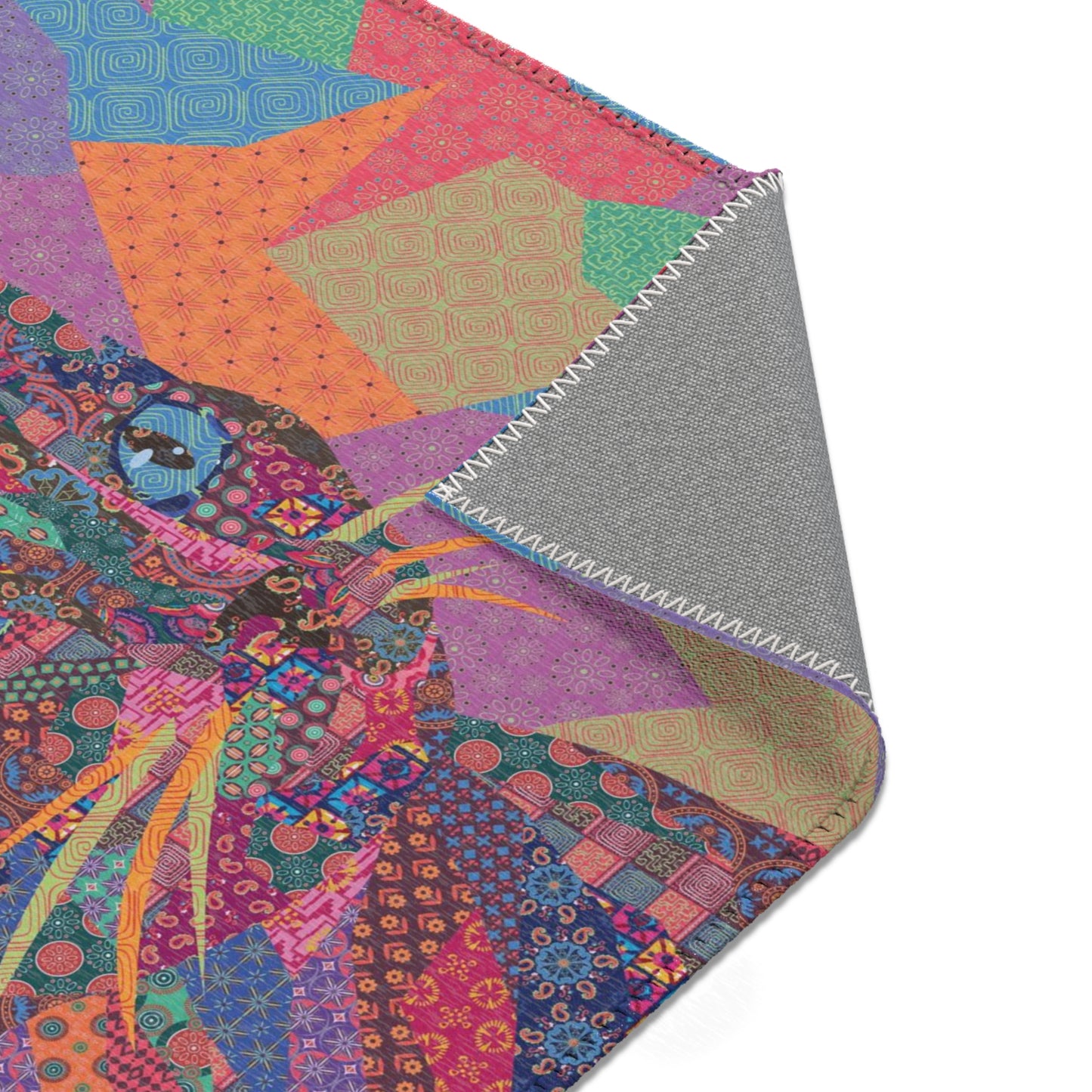Area rug with colorful abstract cat design on a geometric patterned background