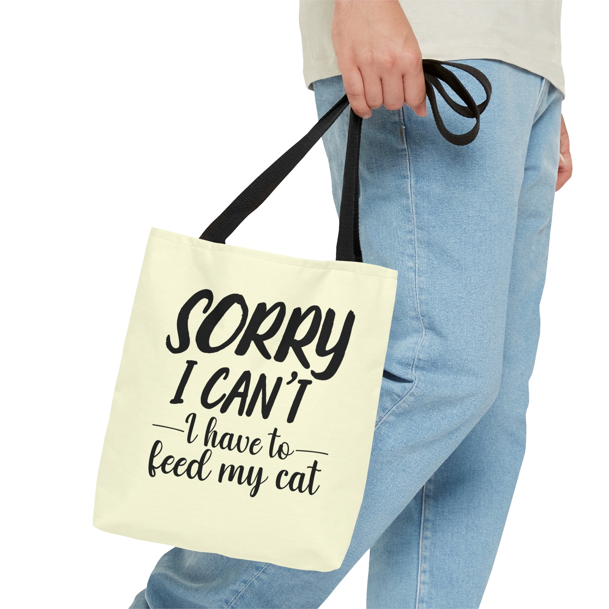 Tote bag with 'Sorry I Can't, I Have to Feed My Cat' text on a cream background
