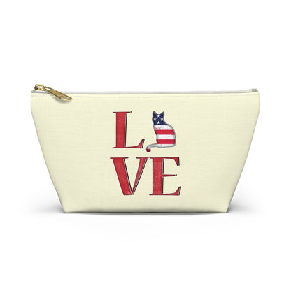 Cream color zipped accessory bag for organising makeup, cosmetics, travel essentials, toiltries, pencil case with 'LOVE' text and cat graphics in the colors of the American flag.