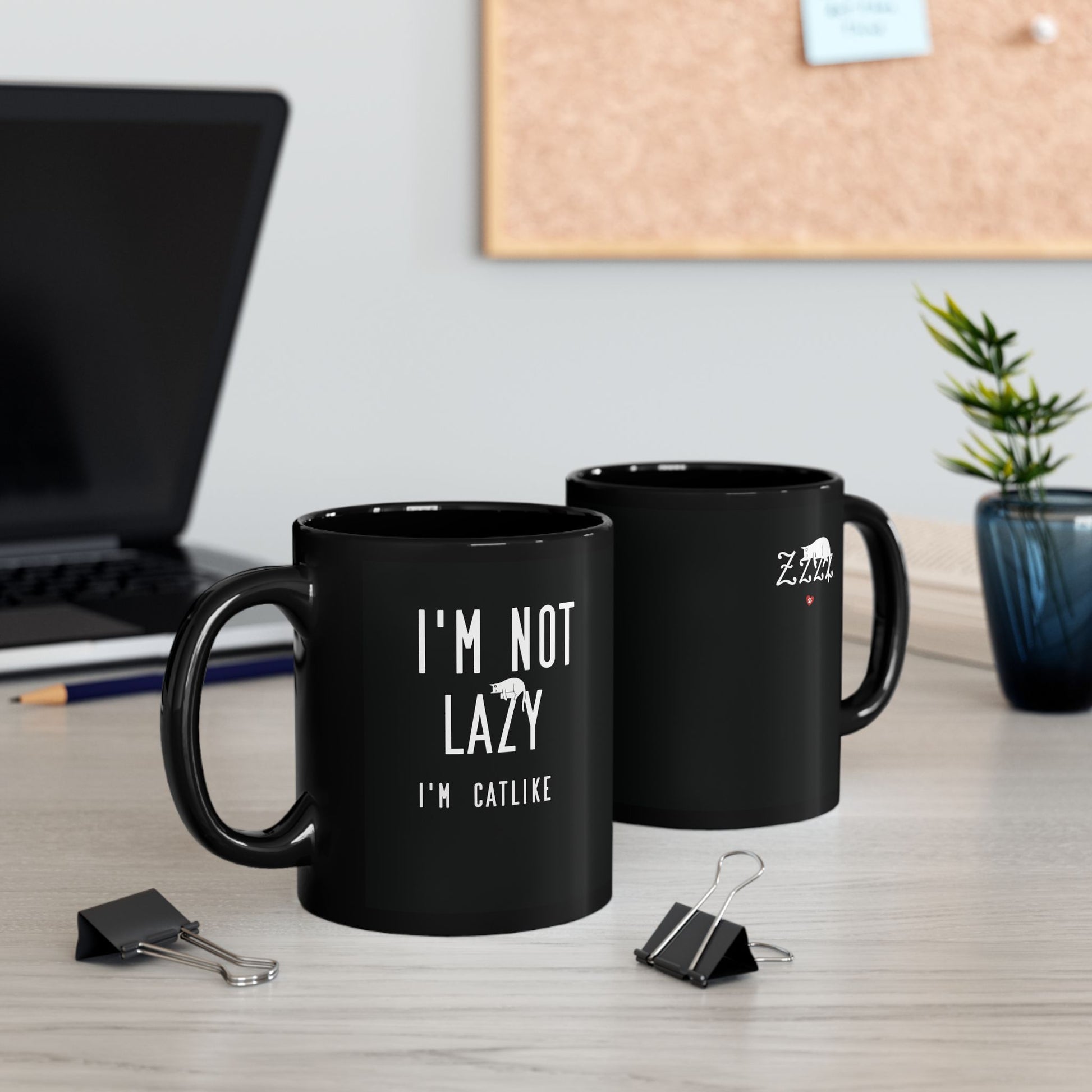 Black mug with white text 'I'm not lazy, I'm catlike' and cat illustration.
