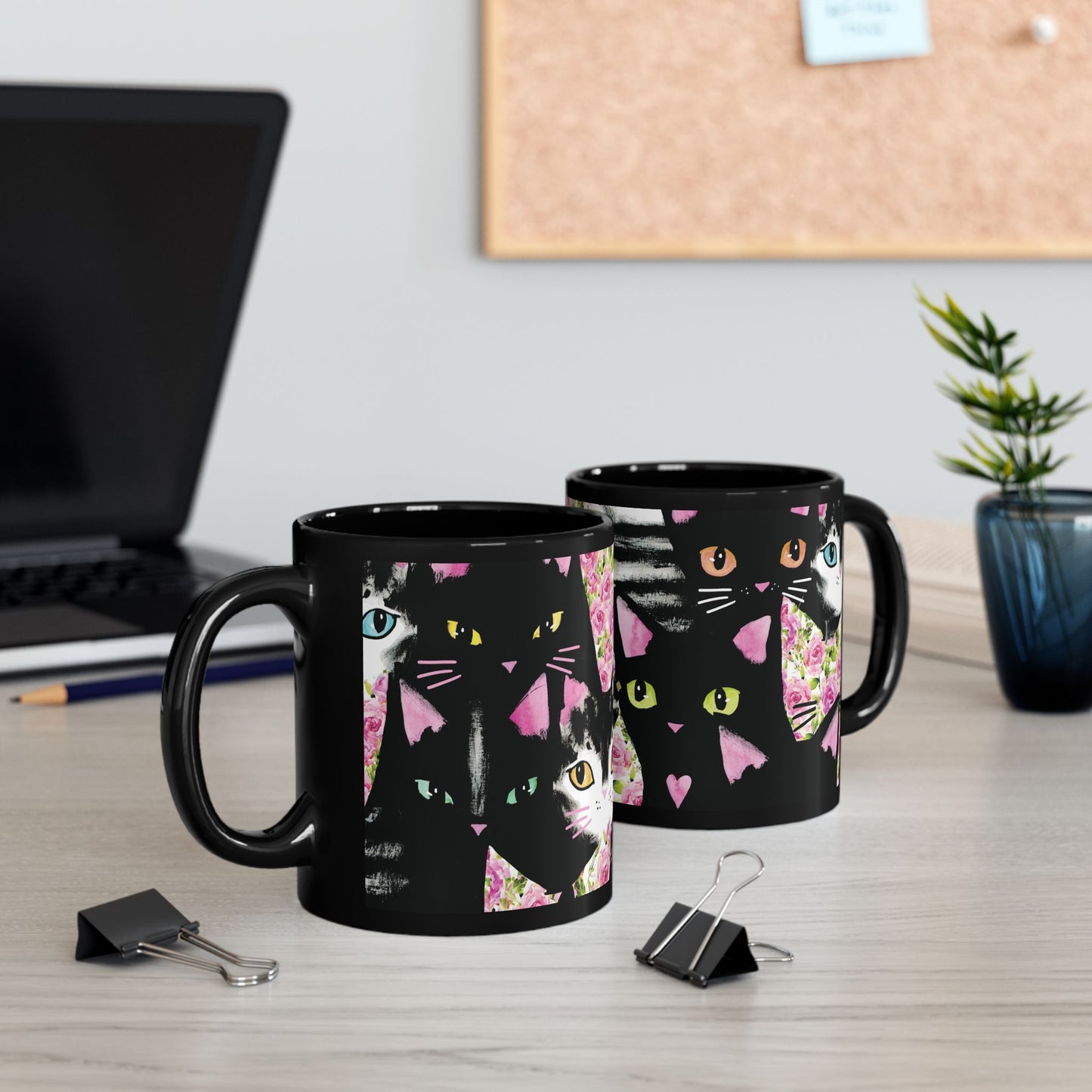 Black mug with a colorful abstract cat design.