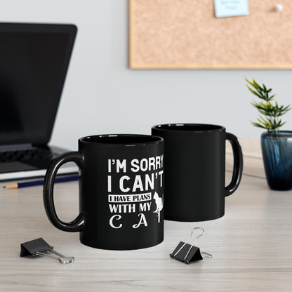 Black mug with white text "I'm Sorry I Can't I Have Plans With My Cat" and a cat graphic.