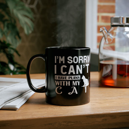 Black mug with white text "I'm Sorry I Can't I Have Plans With My Cat" and a cat graphic.