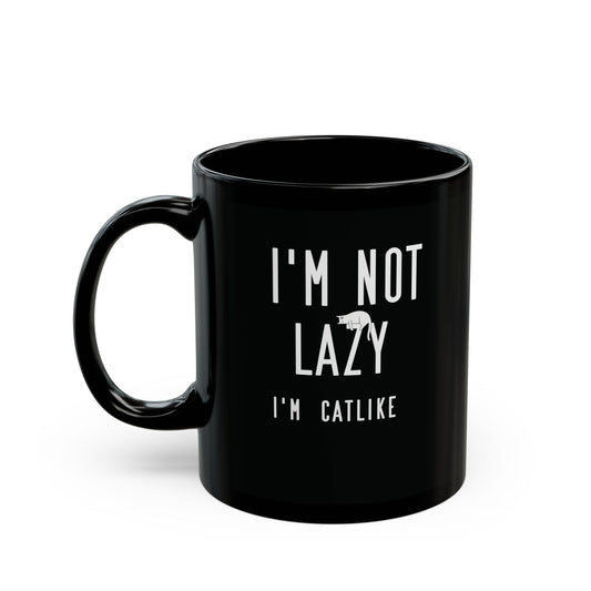 Black mug with white text 'I'm not lazy, I'm catlike' and cat illustration.