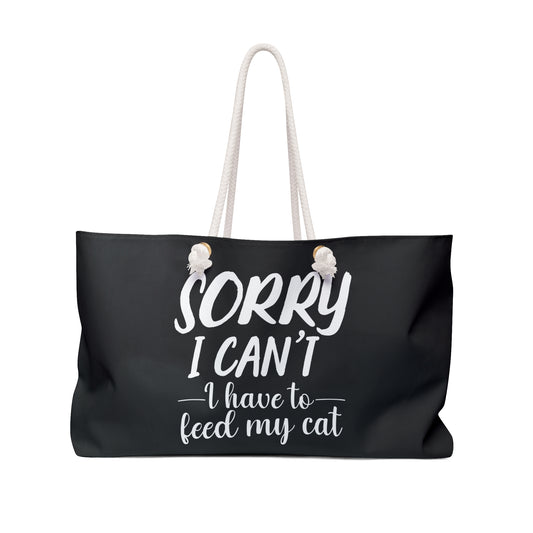 Black weekender tote bag with white text 'Sorry I can't, I have to feed my cat'  