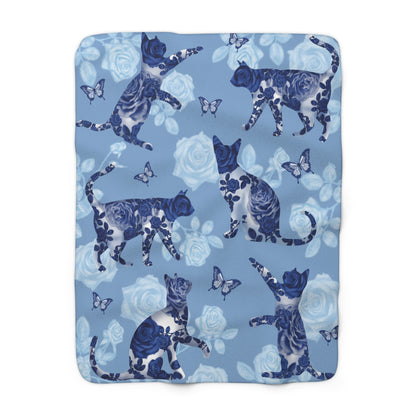 Blue fleece blanket with cats, butterflies and floral pattern.
