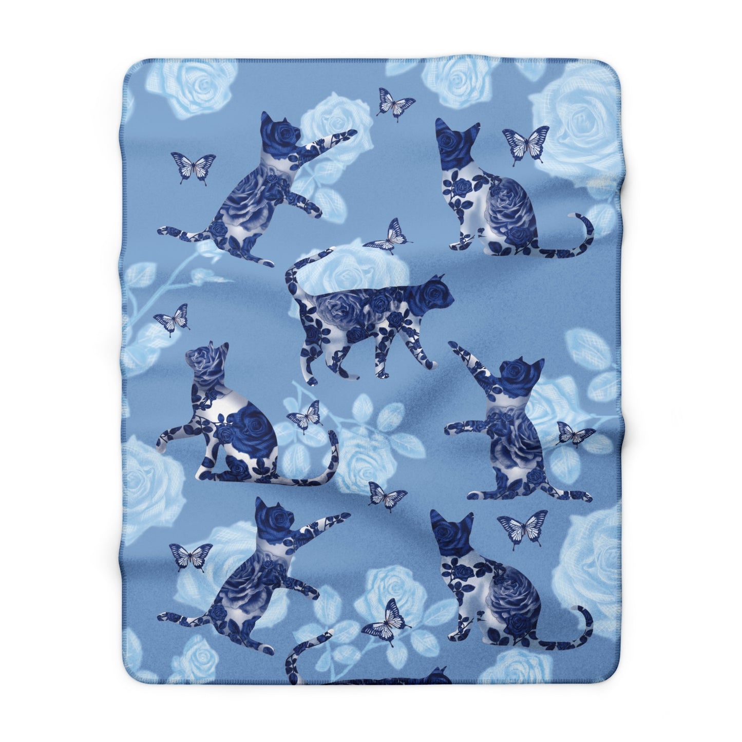 Blue fleece blanket with cats, butterflies and floral pattern.
