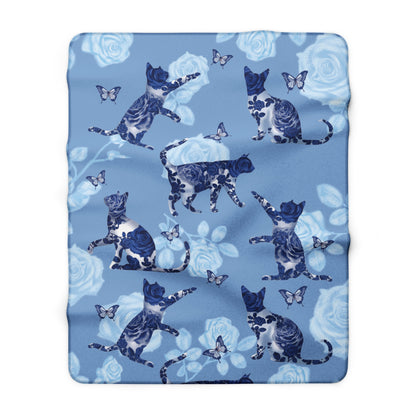 Blue fleece blanket with cats, butterflies and floral pattern.