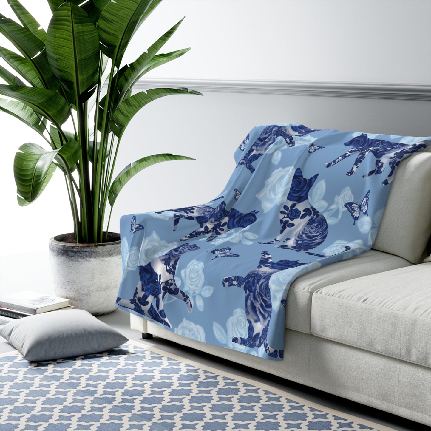 Blue fleece blanket with cats, butterflies and floral pattern.