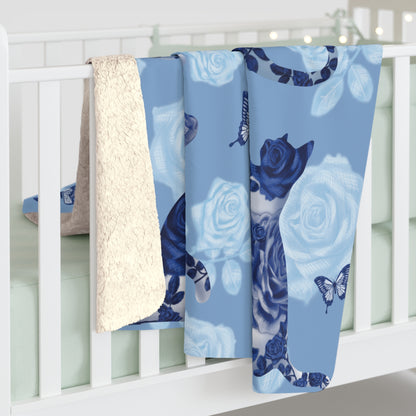 Blue fleece blanket with cats, butterflies and floral pattern.