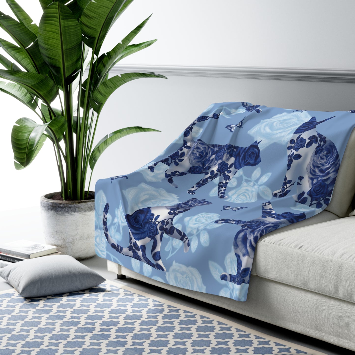 Blue fleece blanket with cats, butterflies and floral pattern.
