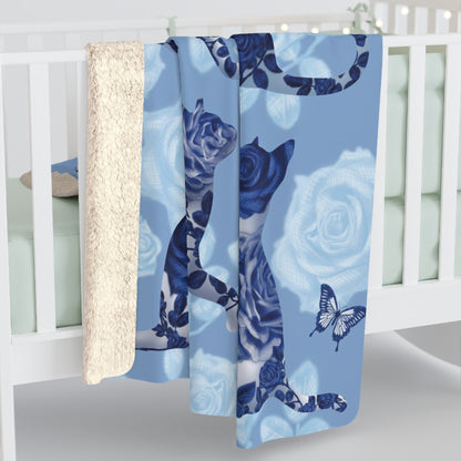 Blue fleece blanket with cats, butterflies and floral pattern.