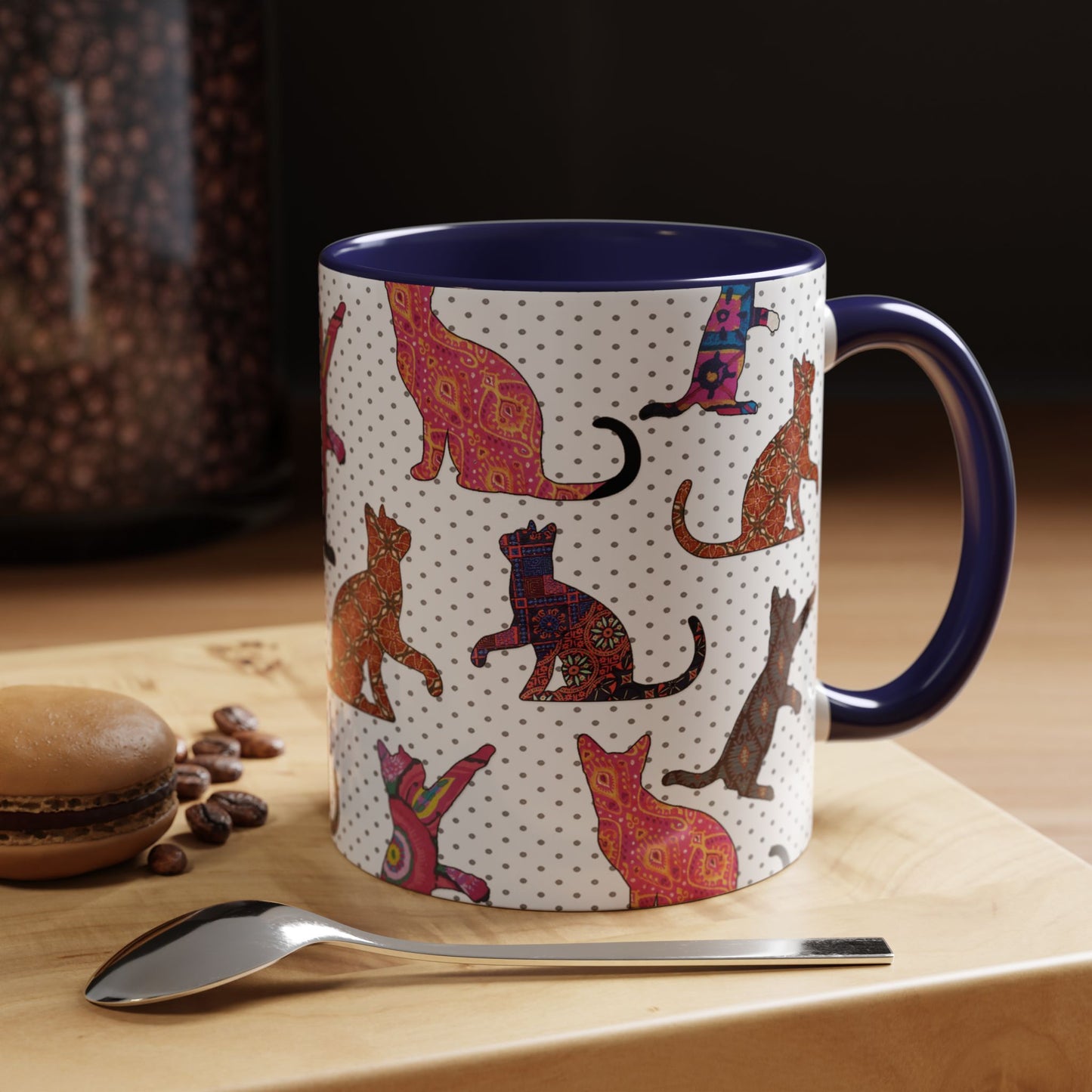 Navy mug with colorful cat silhouette pattern.