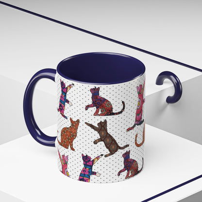 Navy mug with colorful cat silhouette pattern.