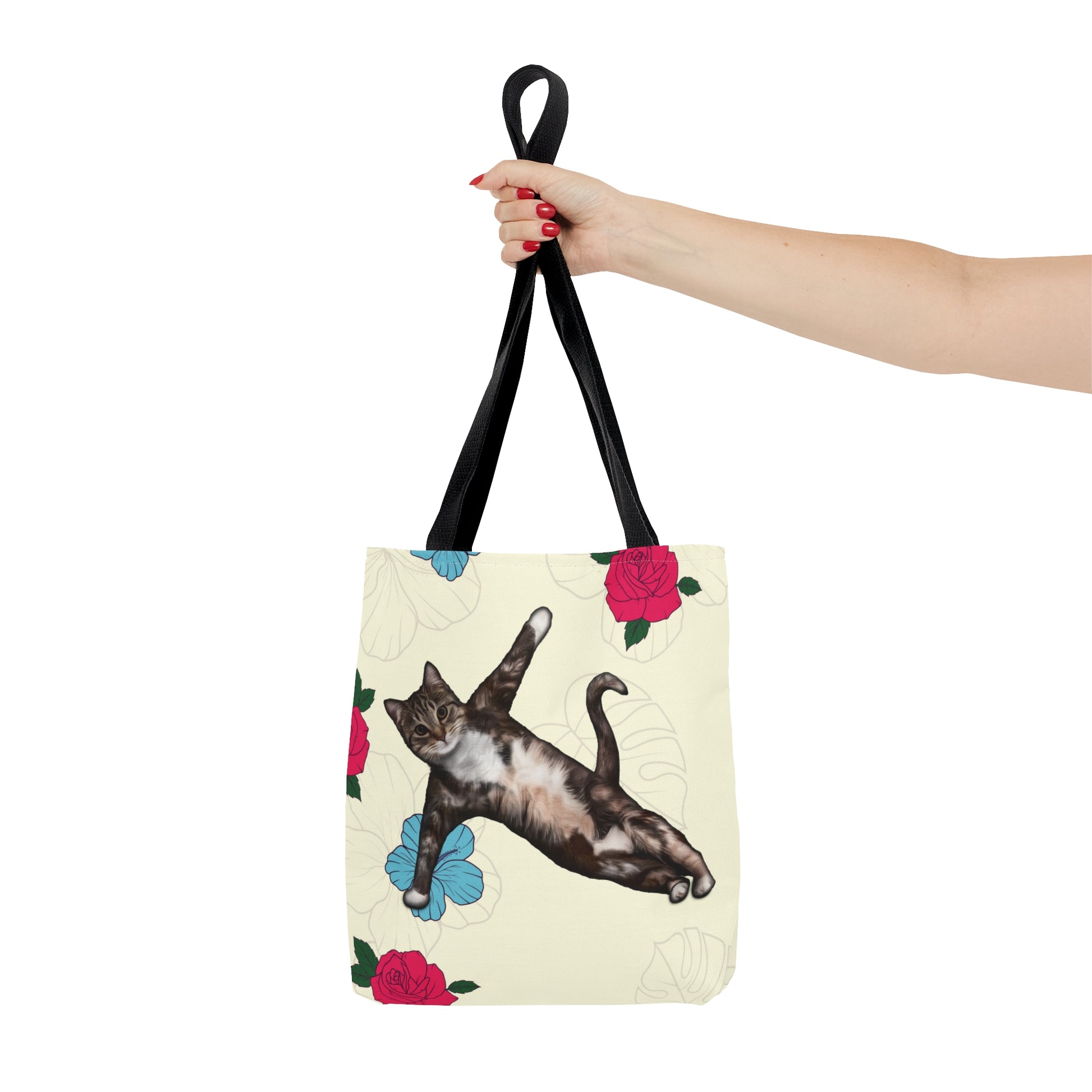 Tote bag with a cat in a yoga pose illustration against floral design on a cream background