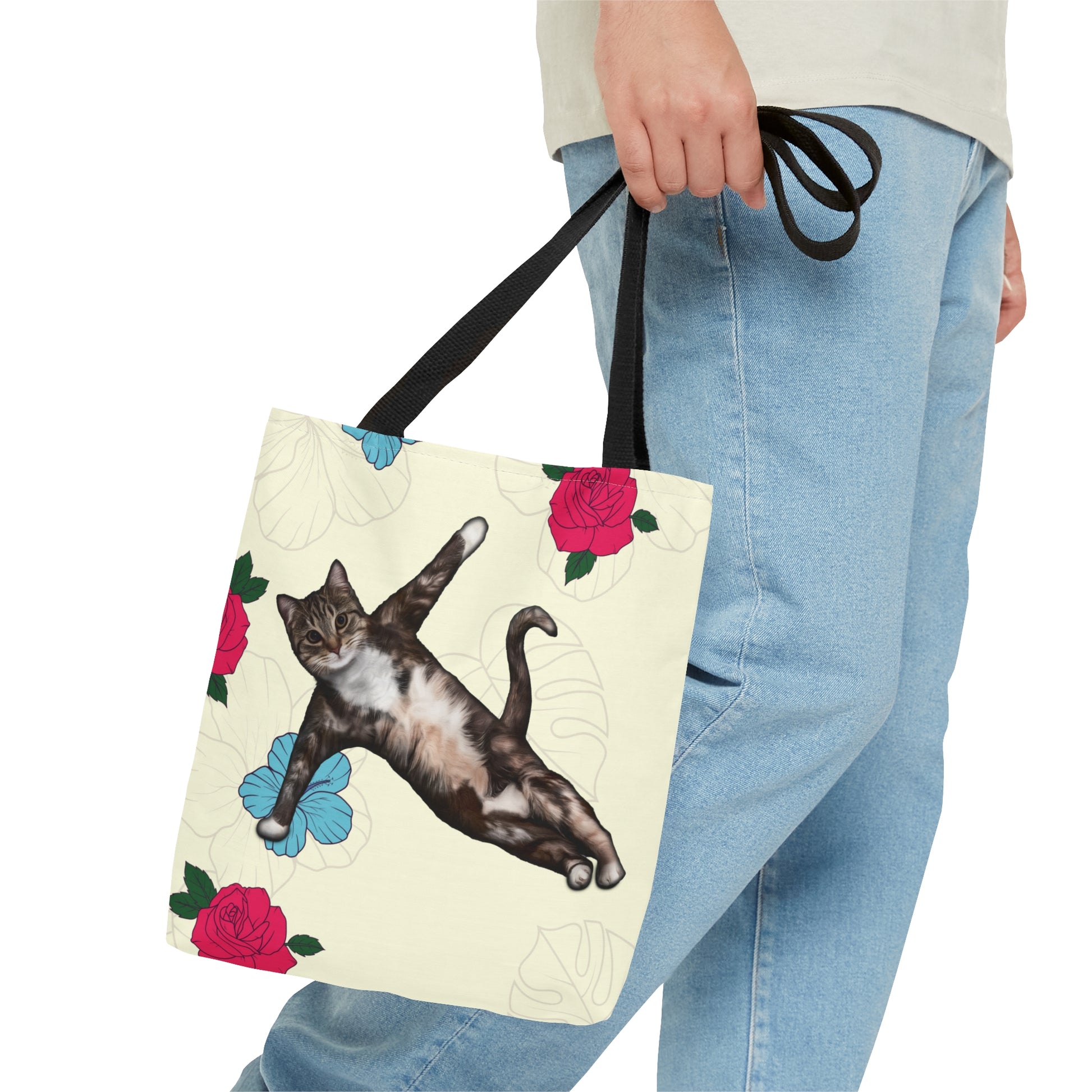 Tote bag with a cat in a yoga pose illustration against floral design on a cream background