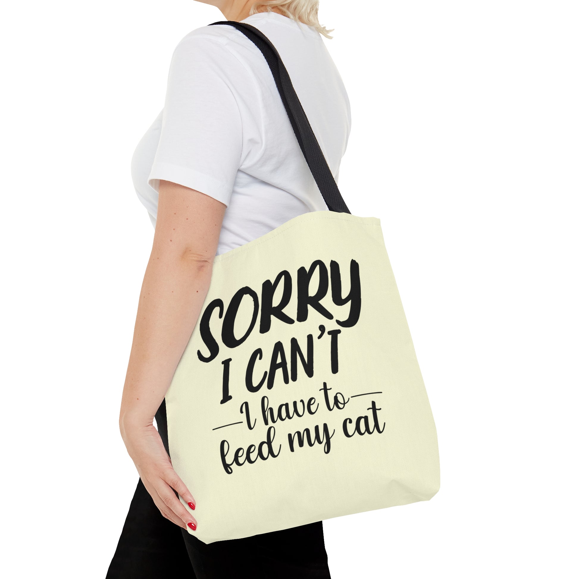 Tote bag with 'Sorry I Can't, I Have to Feed My Cat' text on a cream background