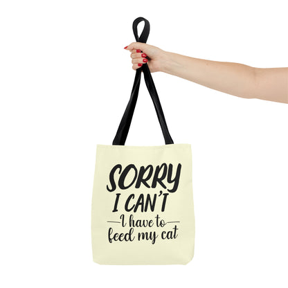Tote bag with 'Sorry I Can't, I Have to Feed My Cat' text on a cream background