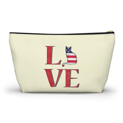 Cream color zipped accessory bag for organising makeup, cosmetics, travel essentials, toiltries, pencil case with 'LOVE' text and cat graphics in the colors of the American flag.