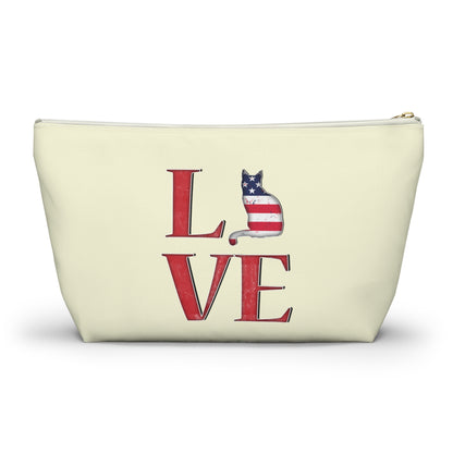 Cream color zipped accessory bag for organising makeup, cosmetics, travel essentials, toiltries, pencil case with 'LOVE' text and cat graphics in the colors of the American flag.