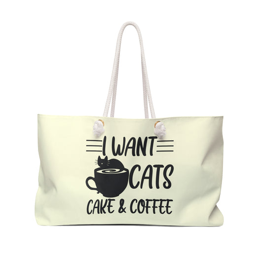 Cream colored weekender tote bag with the text 'I Want Cats, Cake & Coffee' and graphic of cat and coffee cup