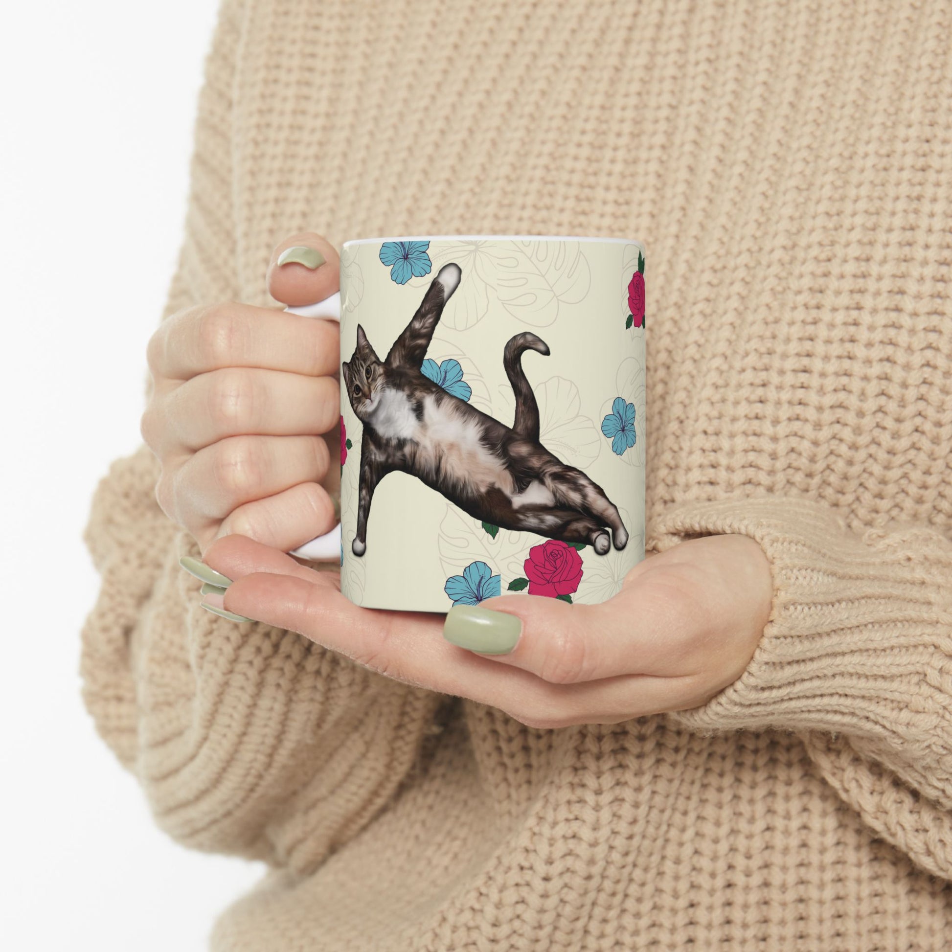 Mug with a cat in a yoga pose on a floral background.