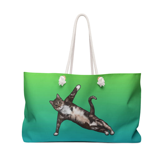 Green colored weekender tote bag with an illustration of a cat in a yoga pose