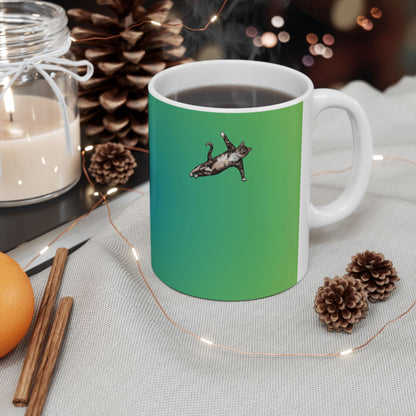 Green mug and graphic of a cat in a yoga pose.