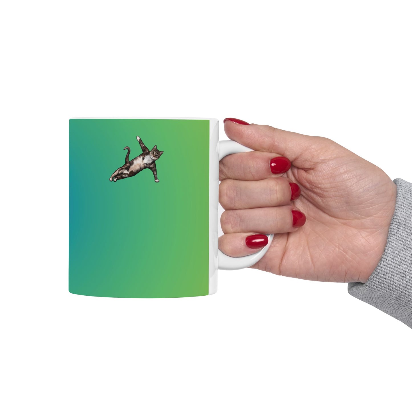 Green mug and graphic of a cat in a yoga pose.