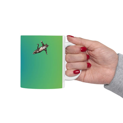 Green mug and graphic of a cat in a yoga pose.