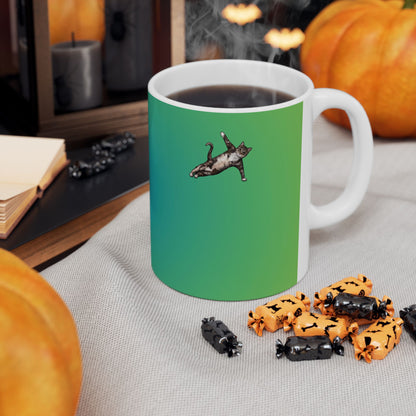Green mug and graphic of a cat in a yoga pose.