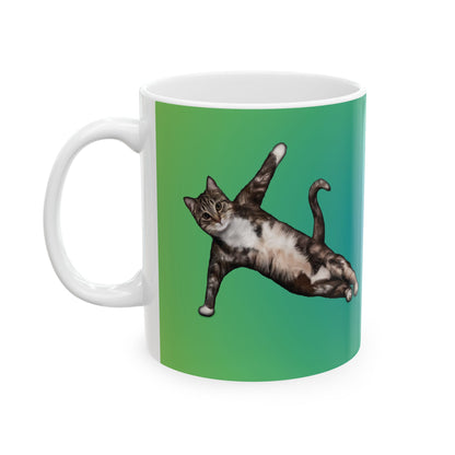 Green mug and graphic of a cat in a yoga pose.