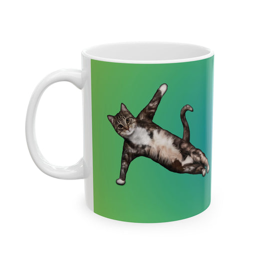 Green mug and graphic of a cat in a yoga pose.