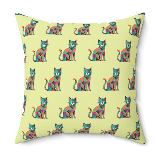 Indoor throw pillow with a repeating geometric pattern of colorful cats in blue, pink, green, and orange.