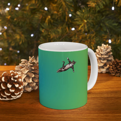 Green mug and graphic of a cat in a yoga pose.