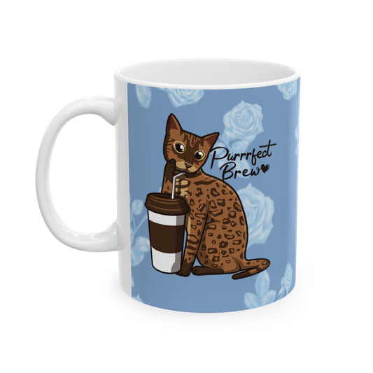 Mug with a Bengal cat drinking from a coffee cup and 'Purrrfect Brew' text on a blue floral patterned background.