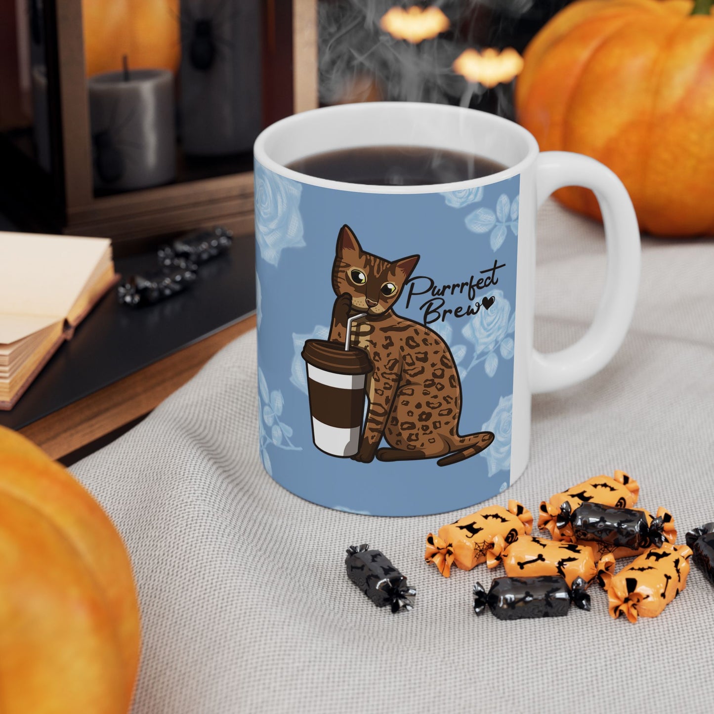 Mug with a Bengal cat drinking from a coffee cup and 'Purrrfect Brew' text on a blue floral patterned background.